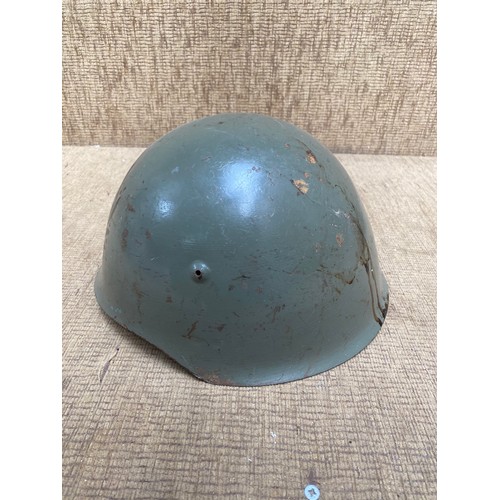 1121 - Two antique military helmets and a selection of military buttons and brass whistle.