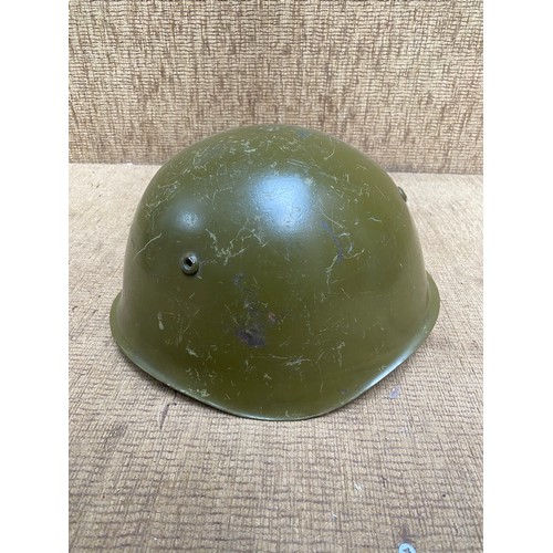 1121 - Two antique military helmets and a selection of military buttons and brass whistle.