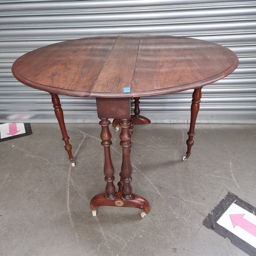 1051 - Antique dropleaf table with original castors.