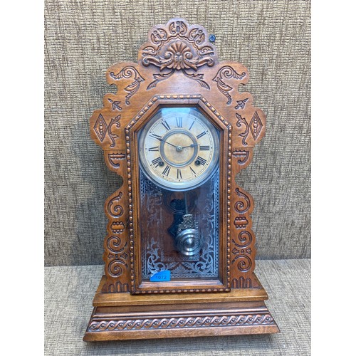 1072 - Antique walnut wind up wall clock with its pendulum.