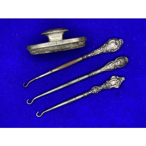 847 - Three Silver Button hooks and a silver blotter.