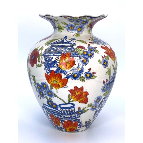 656 - A Large Chinese vase in porcelain, with a white and polychrome design 23cm tall.