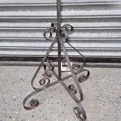 1131 - Wrought iron sculpted tall standing plant stand.