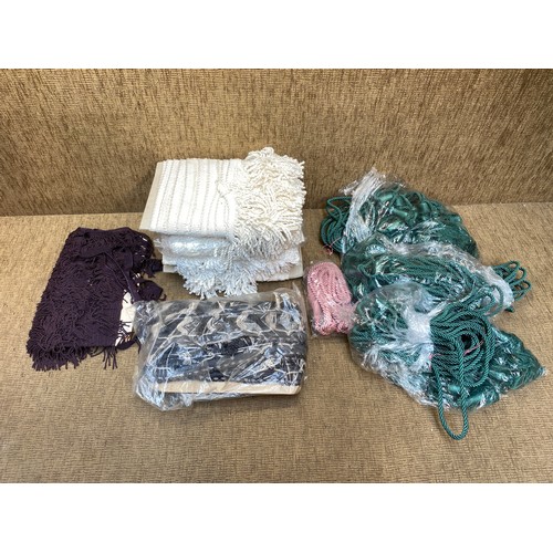 76 - Haberdashery to include silk curtain ties and 150 metres of white fringing.