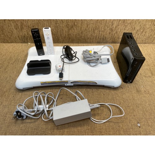 84 - Nintendo Wii console with controllers and Wii fit board.
