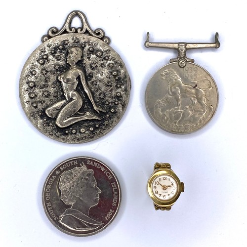 866 - Signs of the Zodiac metal pendant, a WW2 1939-1945 medal, a South Georgia Two pound coin and a yello... 