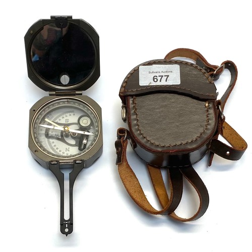 677 - Nautical compass with leather case.