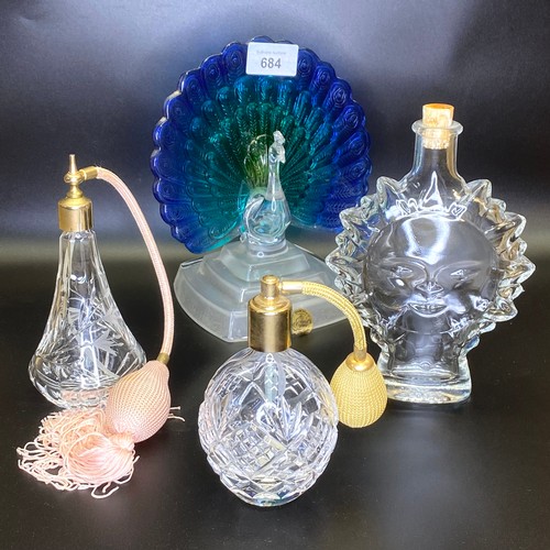 684 - Three glass and crystal perfume/atomiser bottles and a stained glass Peacock.
