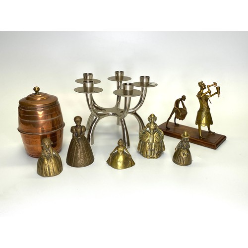 691 - A Sculpted chrome candelabra, 5 Brass Welsh lady bells a copper tea caddy and a brass sculpture on a... 