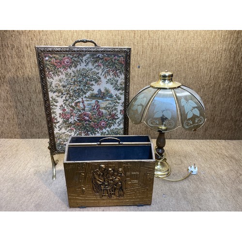 10 - Brass tapestry fire screen, brass magazine rack and a wooden and brass table lamp.