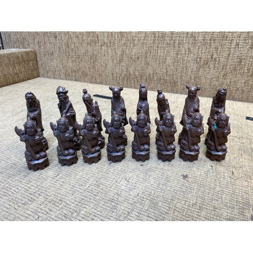 478 - Large wooden Chinese themed chess pieces.