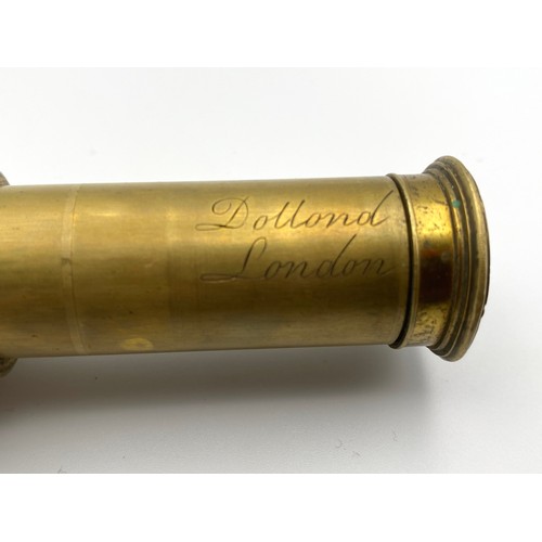 879 - An extendable brass telescope with a leather body. Stamped 