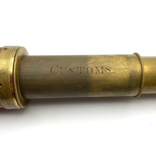 879 - An extendable brass telescope with a leather body. Stamped 