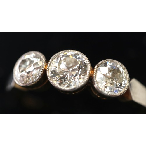 890 - 18ct gold ladies engagement ring with three round diamonds in a platinum mount. (.33k and two at.22c... 