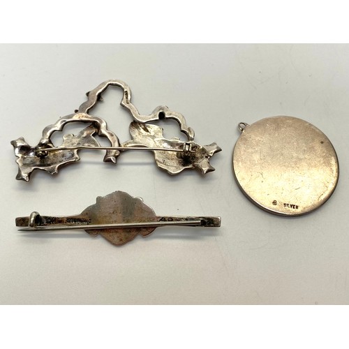 929 - Two Vintage 1950's brooches a swimming fish and a lions head both stamped Sterling to the rear and a... 