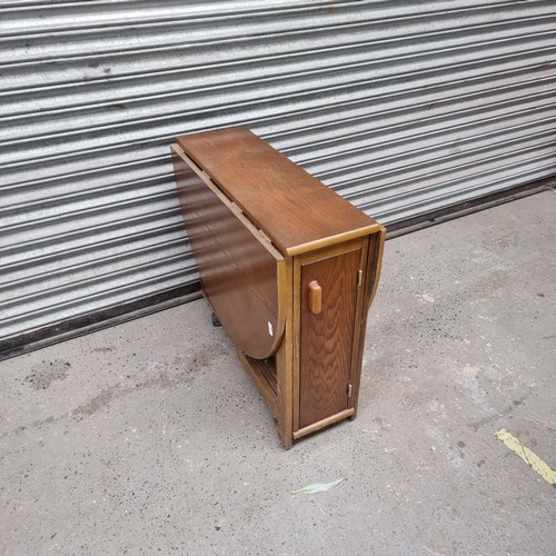 329 - Solid oak drop leaf dinning table with folding chairs that fit inside the table.