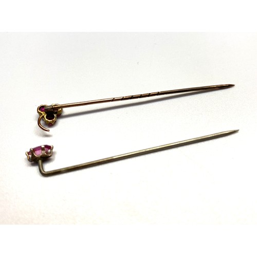 966 - Pink sapphire stick pin and a yellow metal pin with garnets.