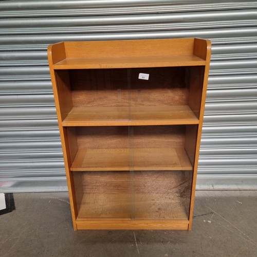 1051F - Odhams Solid A Three tier book pine case with glass sliding draws.