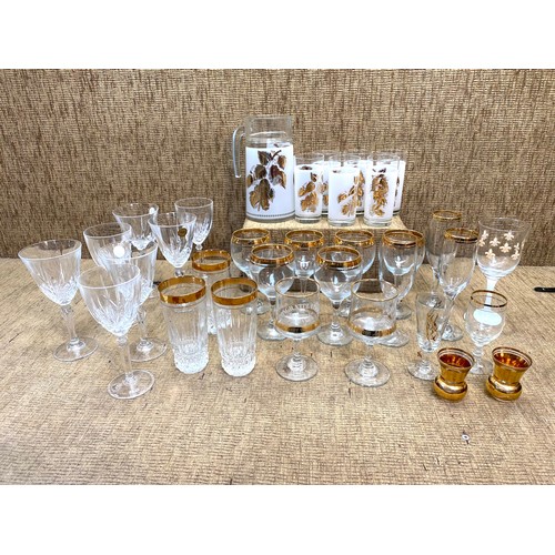 64 - Mixed lot of glasses including a retro cocktail jug and glass set.