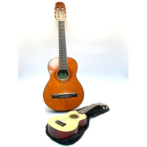 1043 - Spanish made child's acoustic guitar and a Ever joy ukulele in a case.