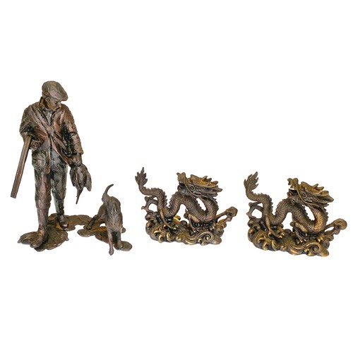653 - Two Chinese dragon bronze figures and a Bronze figure of a huntsman and his dog.