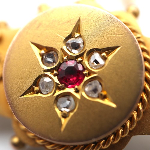 853 - 9ct gold brooch with diamond chips and a ruby. 3.9g