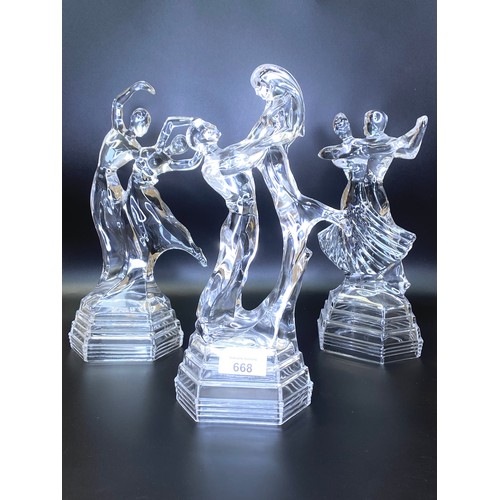 668 - Three cut glass dancing figurines.