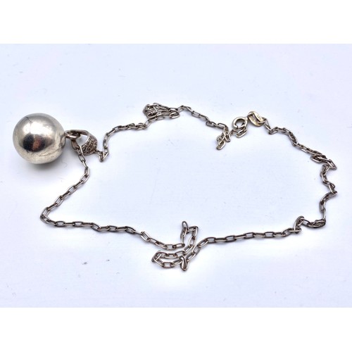 864 - Silver necklace with a large heavy silver ball pendant.
