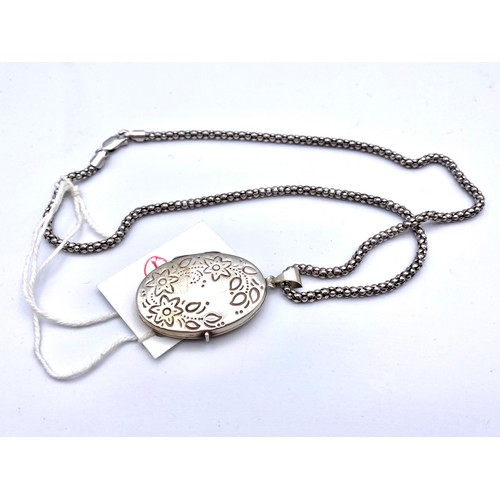 857 - Large silver locket and chain.