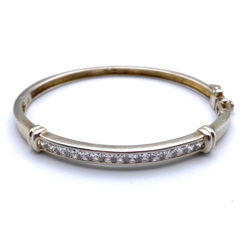 861 - Silver bangle with cubic zirconia..