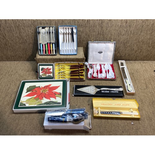 504 - Boxed vintage cutlery and place mats.