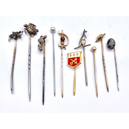 929 - 10 White metal and silver tie pins including some enamel and with gold pins. (NHMMYOMU)