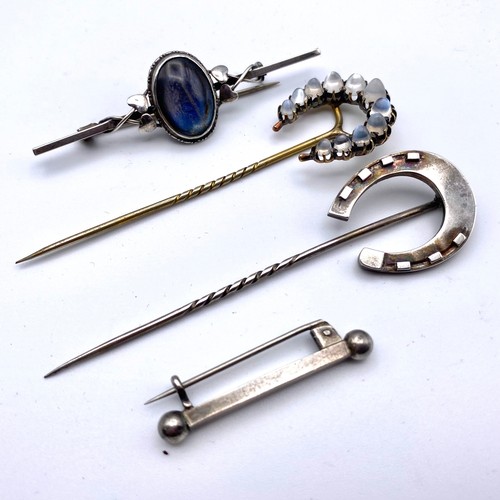 945 - Set of four stunning cravat pins and brooches including silver and a yellow metal long pin. Moonston... 