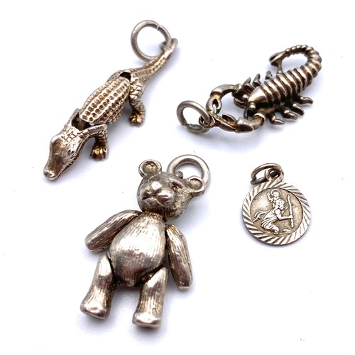 919 - Four silver charms, including two that are articulated, teddy bear alligator, in a wooden box with s... 