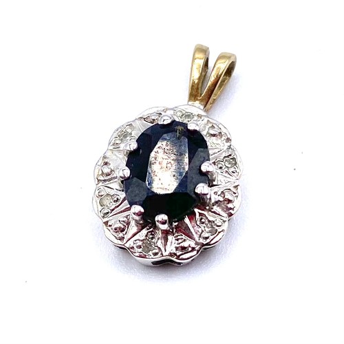 1244 - 9ct gold and white gold pendant with a blue semi precious stone.