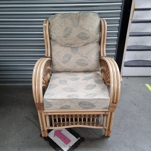 65 - Cream bamboo wicker conservatory chair with floral cushions.