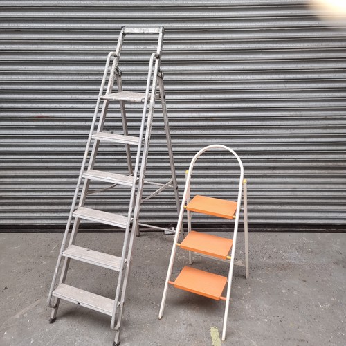 103 - Two sets of metal ladders.