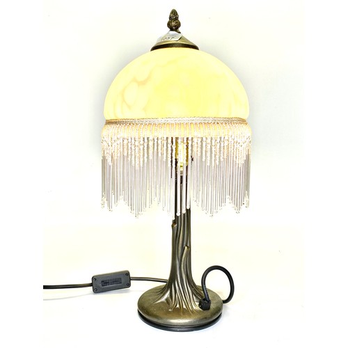 1057 - Metal sculpted lamp with frosted glass shade.