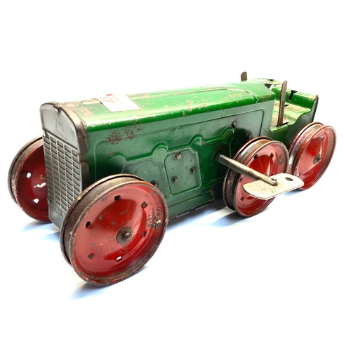 667 - Antique tin plate clockwork tractor with key in working order.