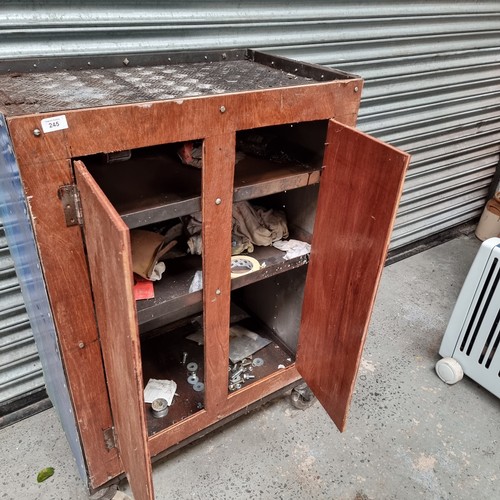 245 - Industrial metal storage unit with wooden drawers and three shelfs inside.