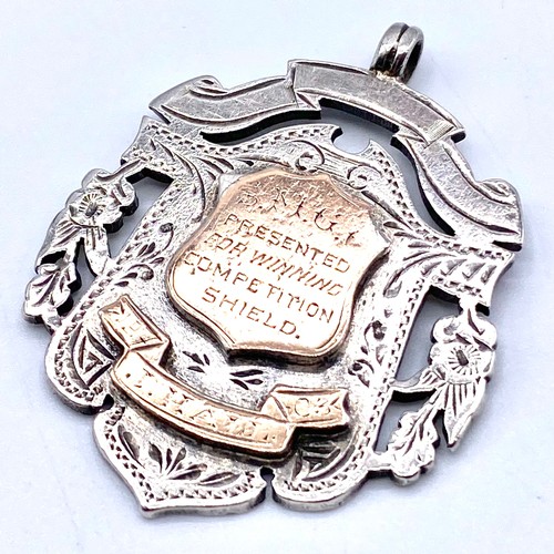 879 - Large sterling silver and gold fob. Awarded for winning the ambulance challenge shield.