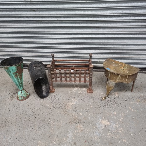 1104 - Antique brass lazy footman stool, cast iron fire grate, metal coal scuttle and a bronzed umbrella st... 