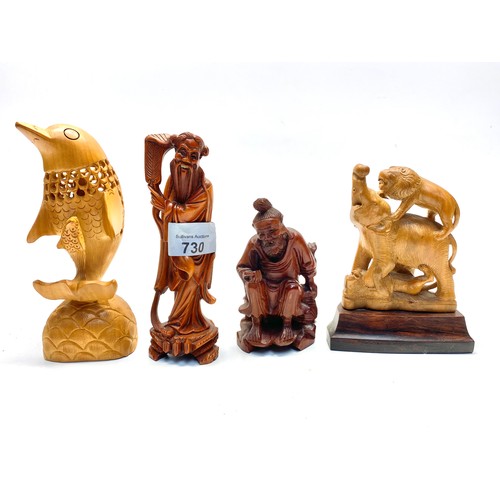 730 - Carved figures including dolphin , african fighting scene and old Japanese man.