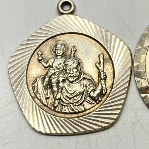 901 - Three silver saint Christopher's including a small one with a silver chain.