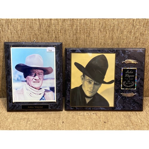 784 - Two John Wayne plaques . 38x30 cm & 34x26 cm.