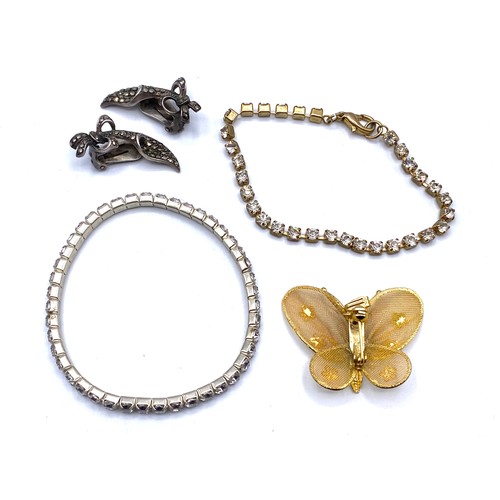 696 - Pretty delicate vintage butterfly brooch/pendant, two paste tennis bracelets and a pair of clip on e... 