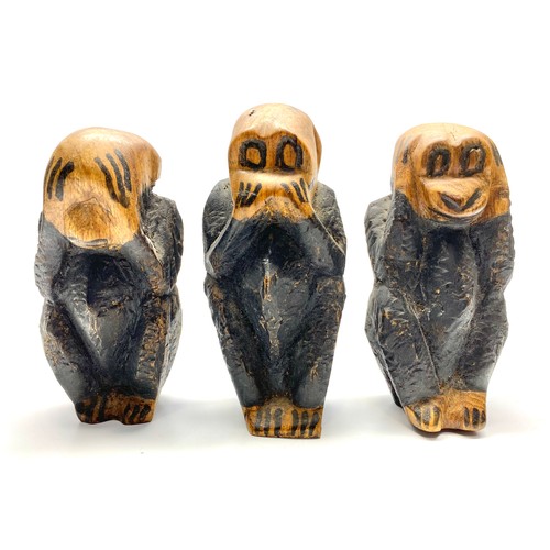 676 - Three folk art carved wooden monkeys.