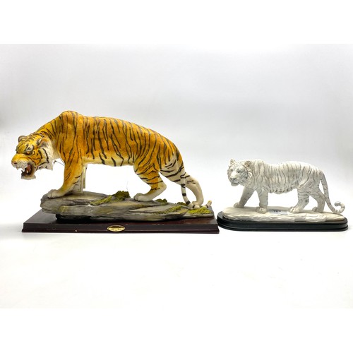 709 - Two tiger figures largest being 28cm high.