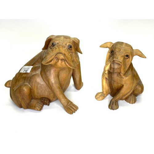 716 - A Pair of hand carved wooden bulldogs.