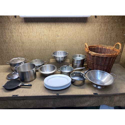 46 - Large quantity of stainless steel pots and pans and a wicker basket.